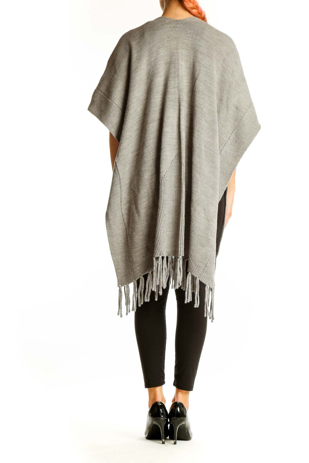 Side view of gray fringed acrylic knit poncho from Ann Taylor on model