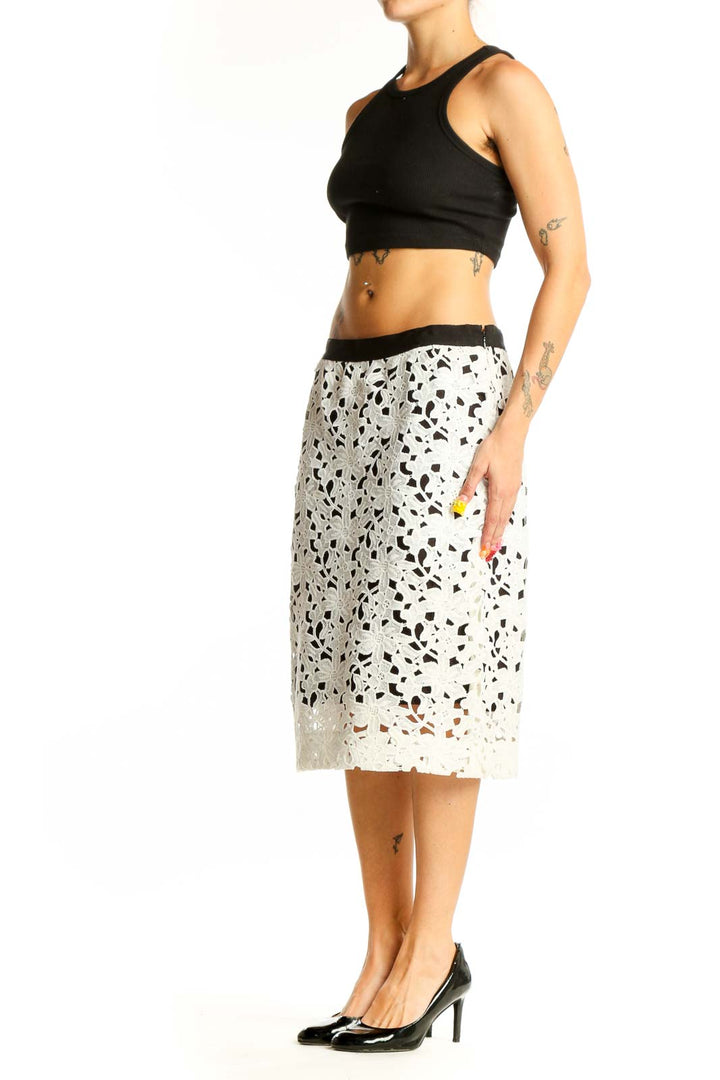 Front view of Cluny white floral lace midi skirt with black waistband