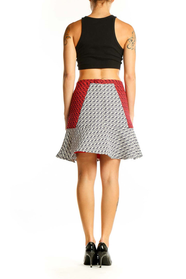 Side view of C. Luce geometric print skirt showing red side panel