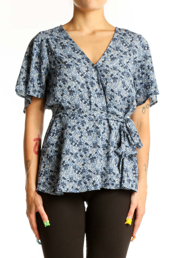 Front view of Bobeau blue floral wrap peplum top with short sleeves