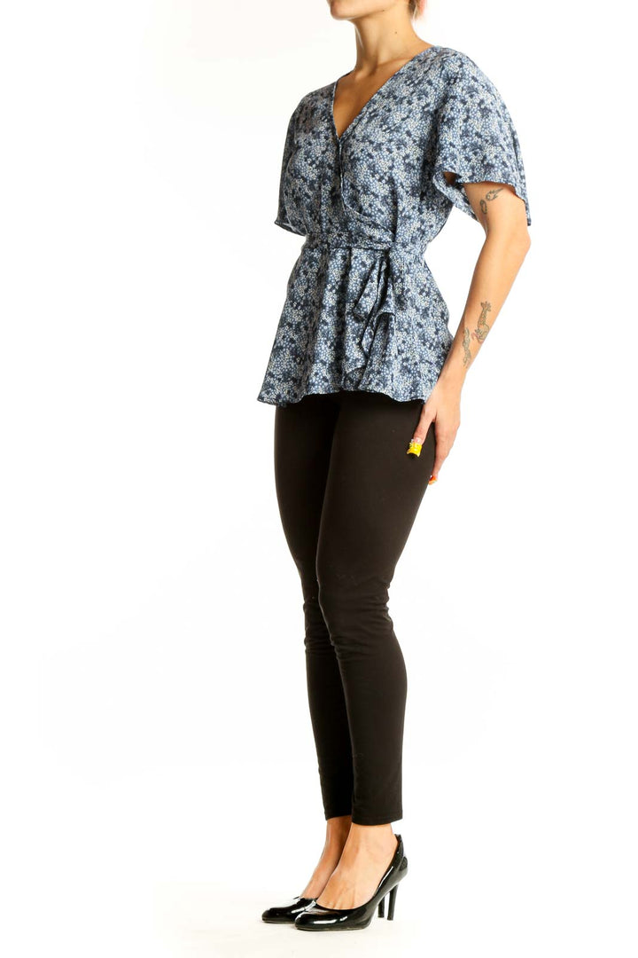Front view of Bobeau blue floral wrap peplum top with short sleeves