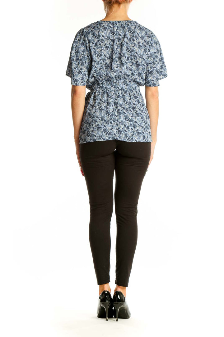 Side view of Bobeau blue floral wrap peplum top showing silhouette