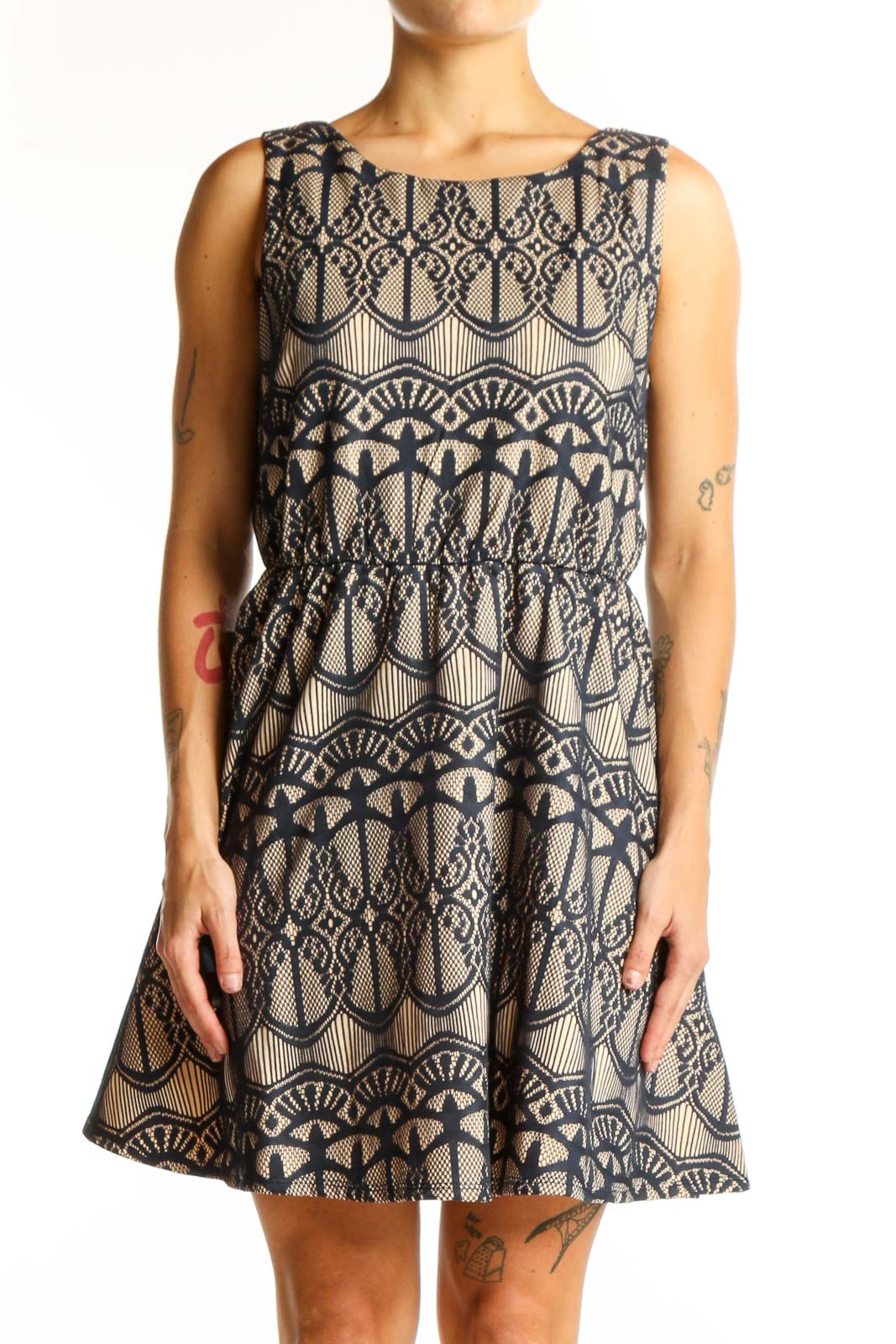 Front view of Want And Need beige sleeveless dress with navy lace pattern