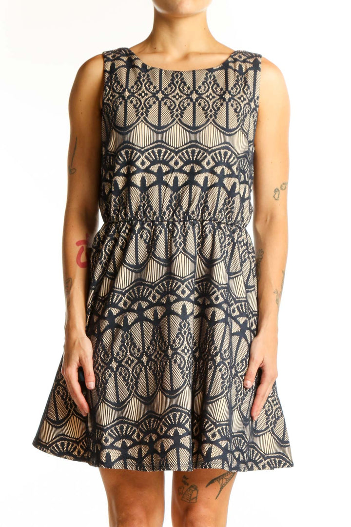 Front view of Want And Need beige sleeveless dress with navy lace pattern
