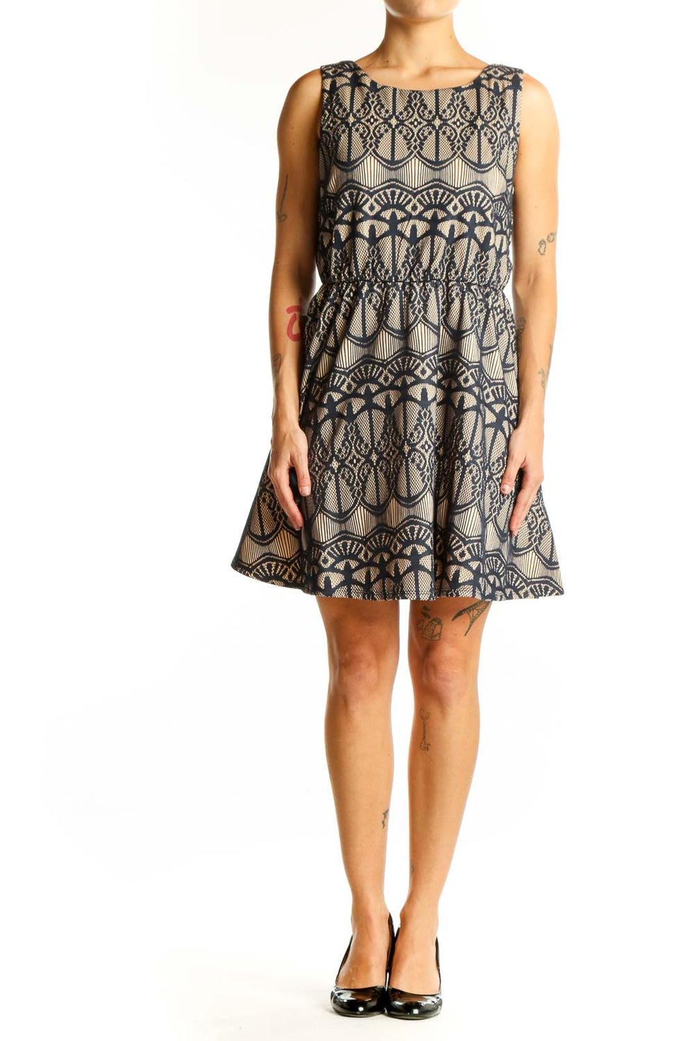 Front view of Want And Need beige sleeveless dress with navy lace pattern