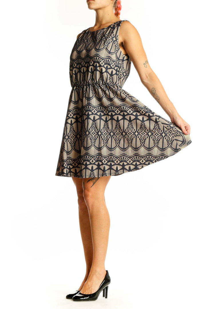 Front view of Want And Need beige sleeveless dress with navy lace pattern
