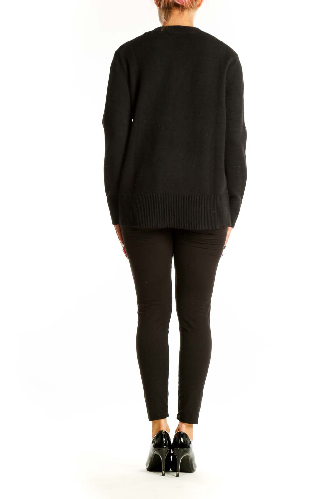 Side view of Banana Republic black crewneck sweater on model with black pants