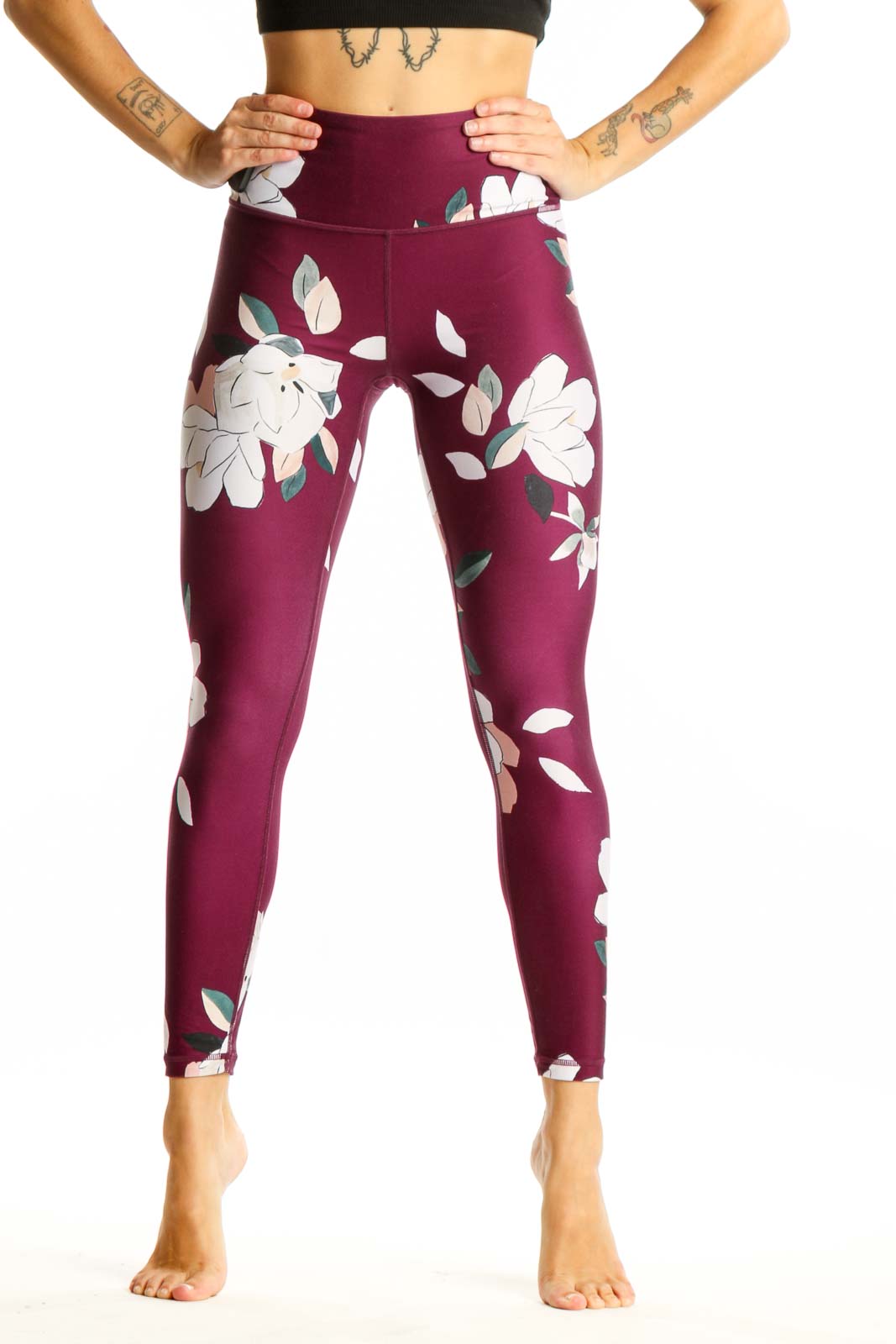 Front view of Athleta burgundy leggings with white floral print