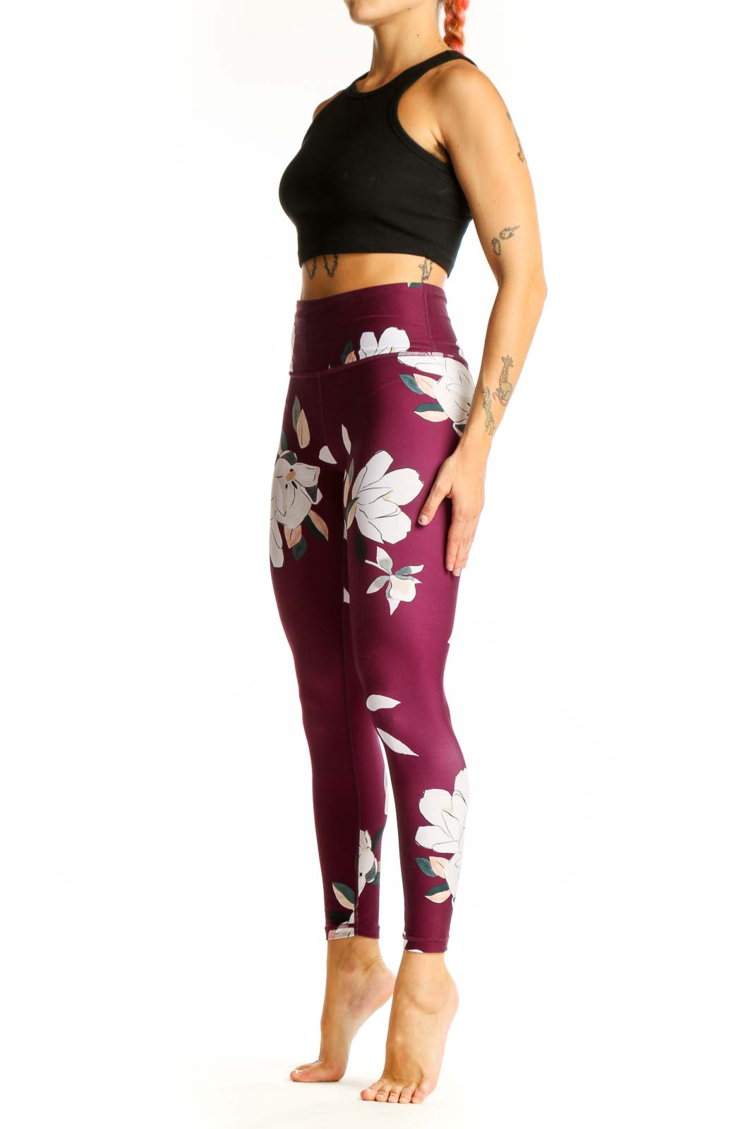 Front view of Athleta burgundy leggings with white floral print