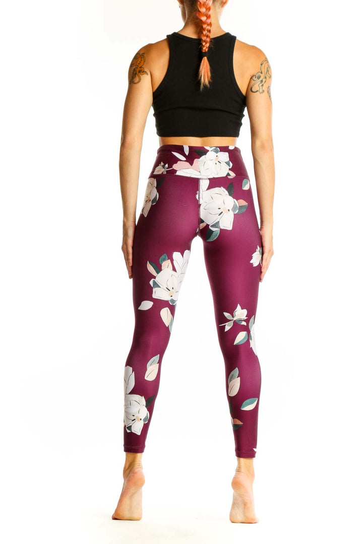 Side view of woman wearing Athleta burgundy floral print leggings