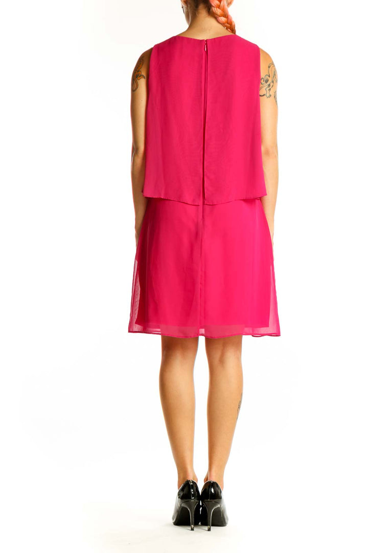 Side view of hot pink Vince Camuto sleeveless layered cocktail dress