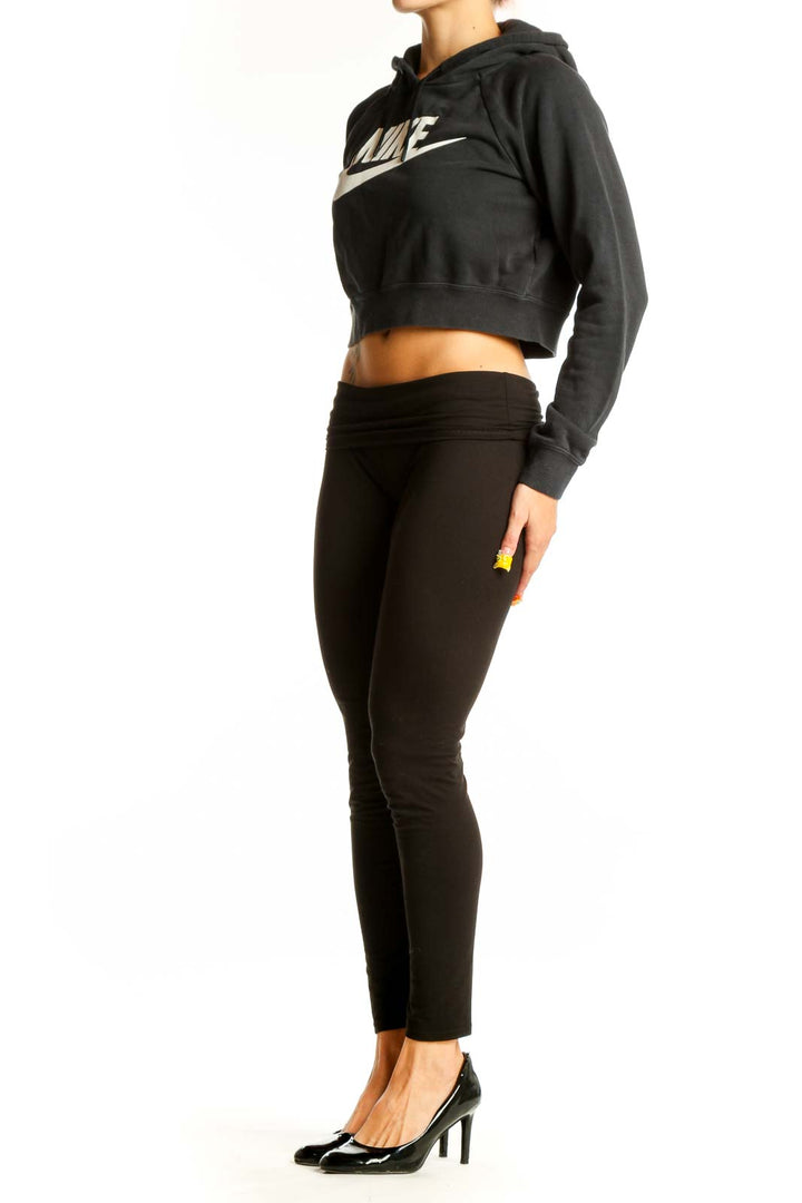 Front view of black Nike cropped hoodie with white swoosh logo