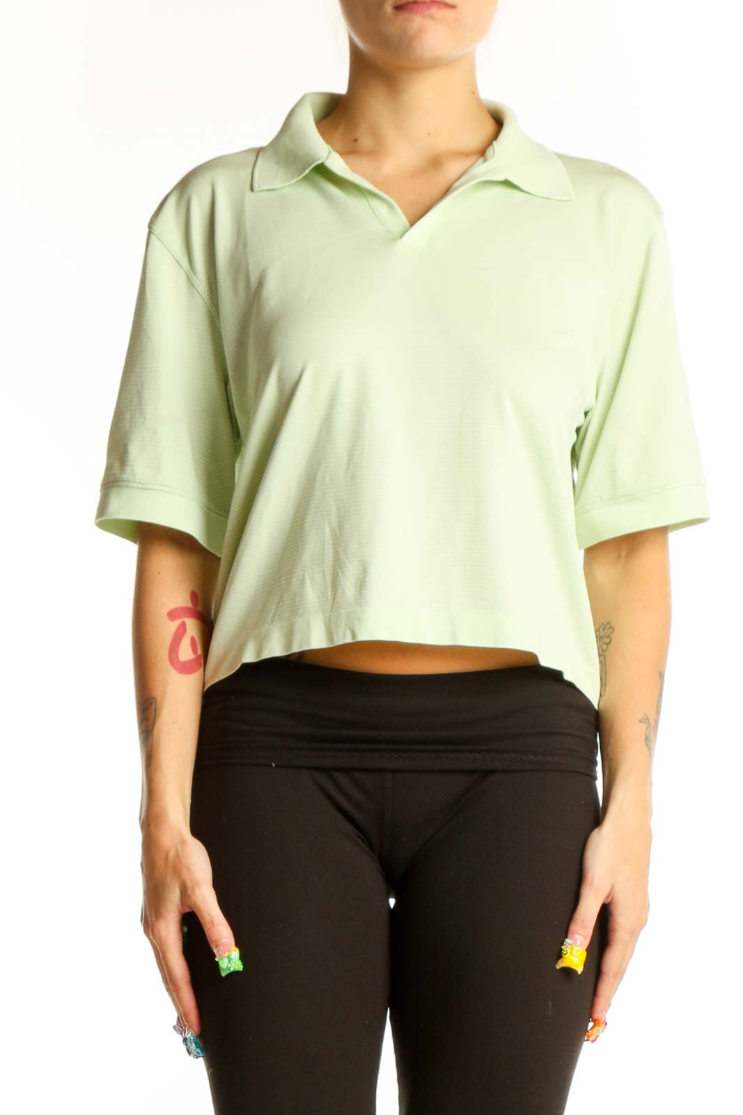 Front view of Lululemon mint green cropped polo top