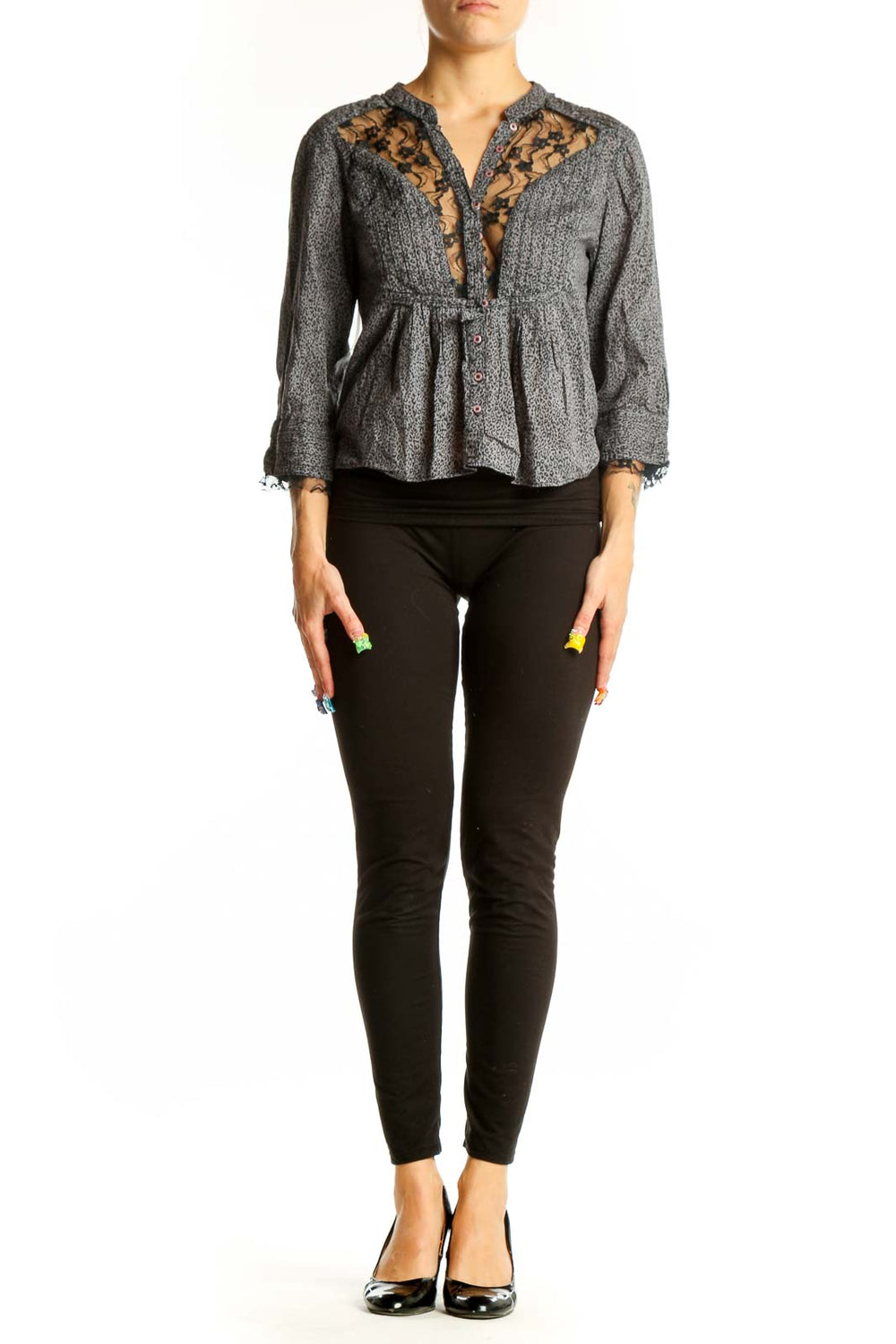 Front view of gray Free People peplum blouse with lace trim and button detail