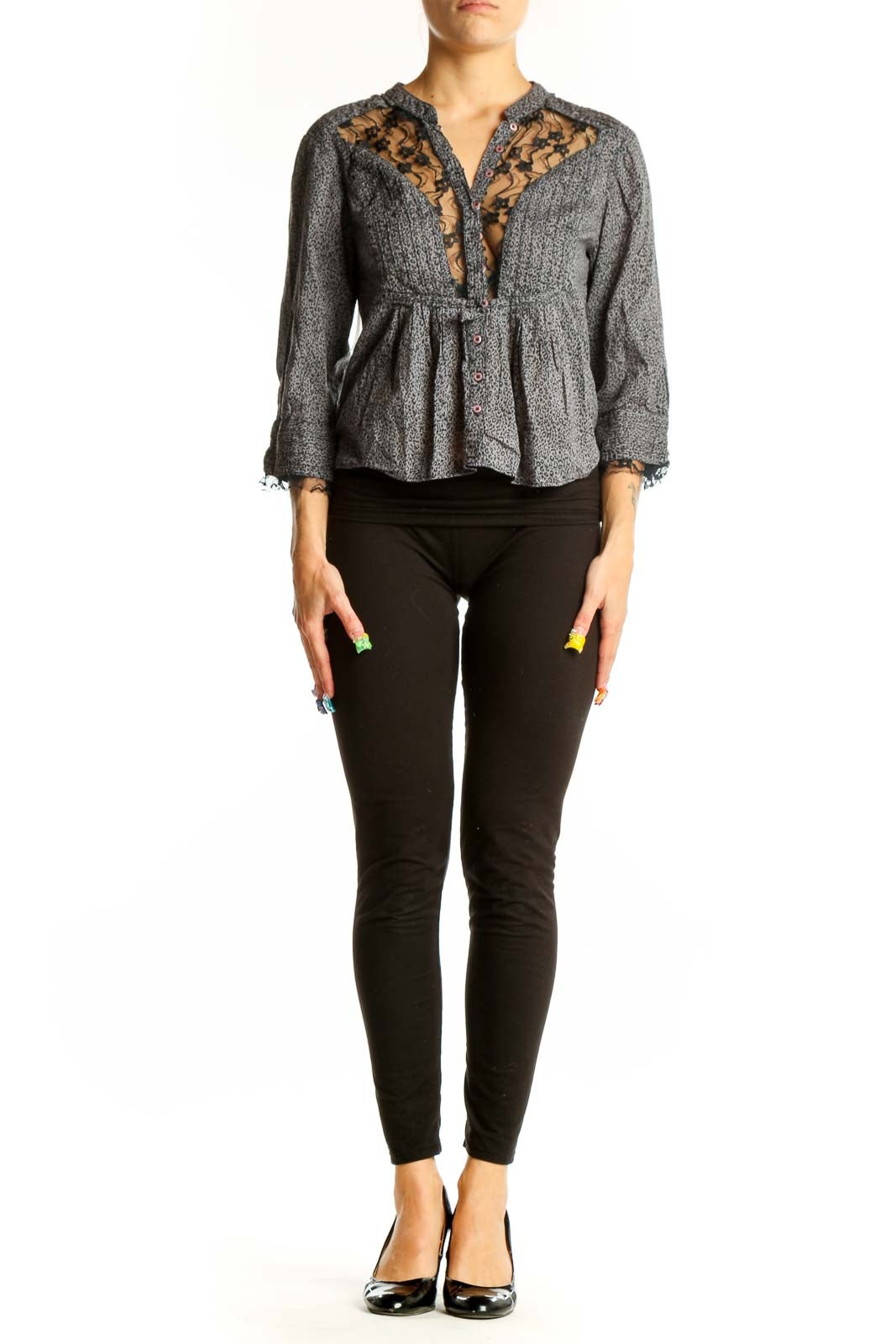 Front view of gray Free People peplum blouse with lace trim and button detail