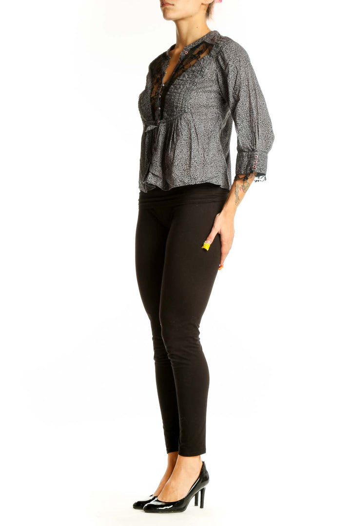 Front view of gray Free People peplum blouse with lace trim and button detail