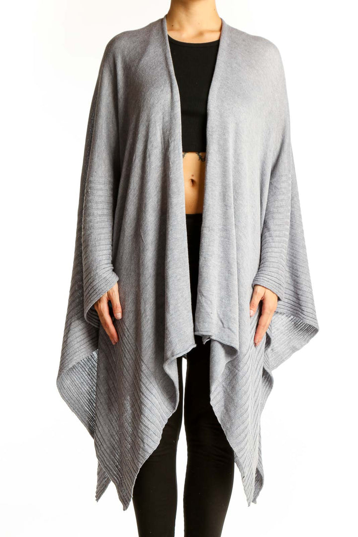 Front view of gray oversized knit poncho with ribbed edges