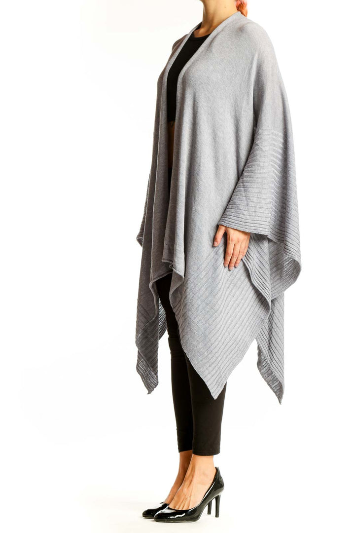 Front view of gray oversized knit poncho with ribbed edges