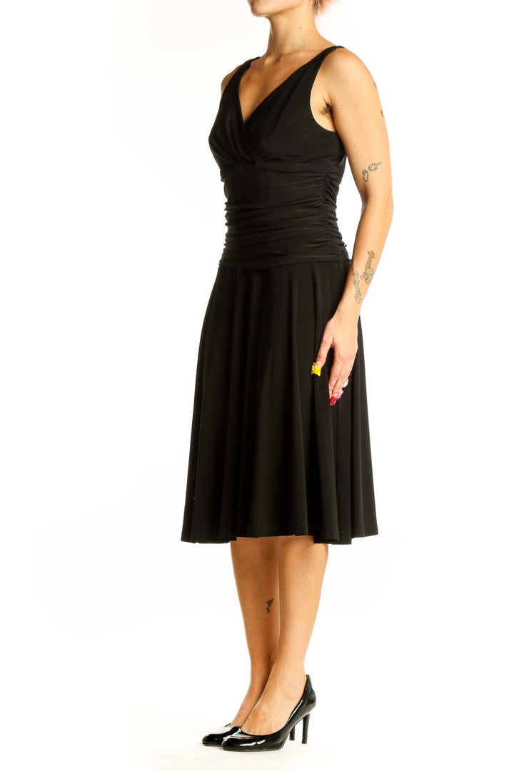 Front view of black V-neck cocktail dress with ruched waistline