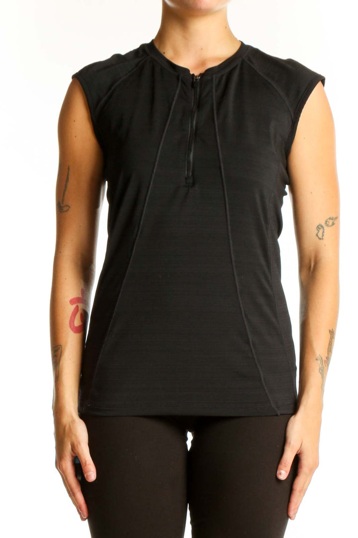 Front view of black Athleta sleeveless athletic top with half-zip