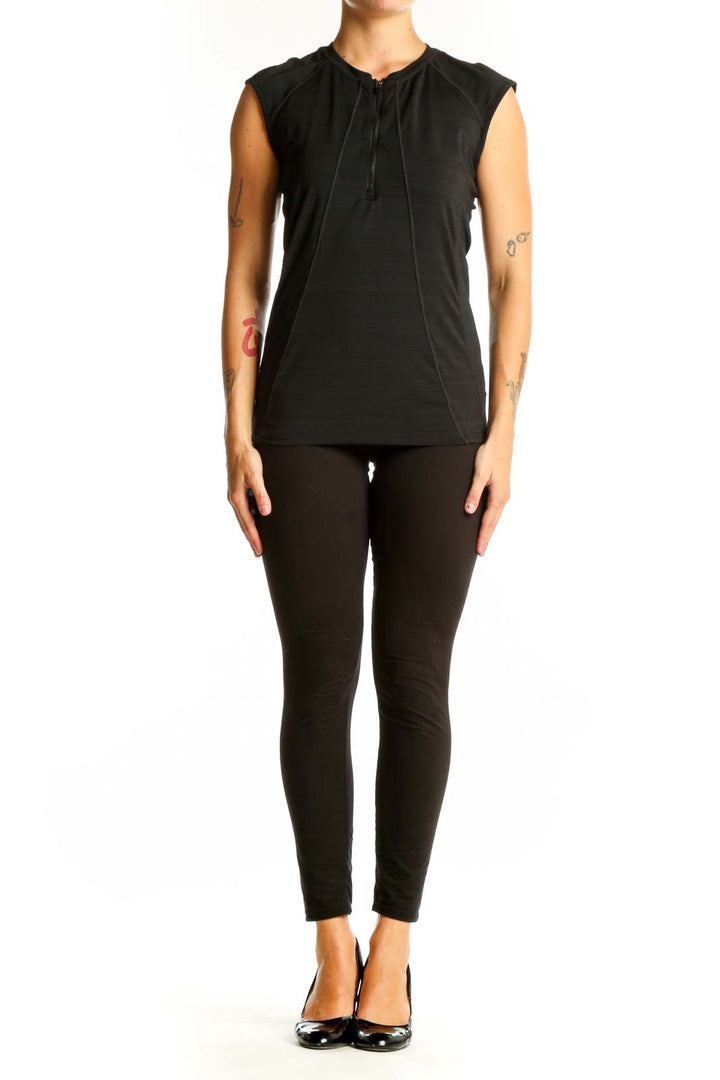 Front view of black Athleta sleeveless athletic top with half-zip