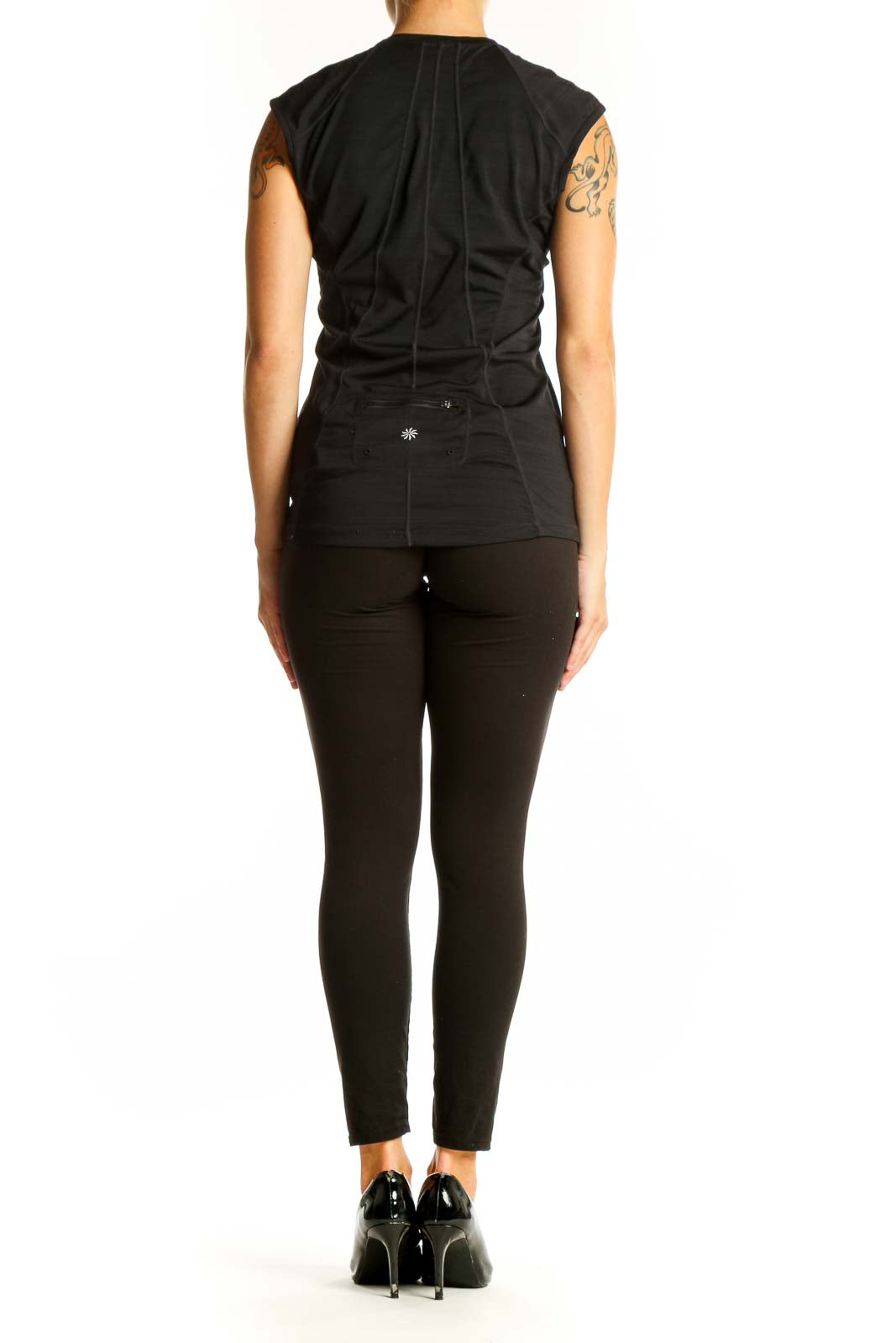 Side view of woman wearing black Athleta sleeveless athletic top