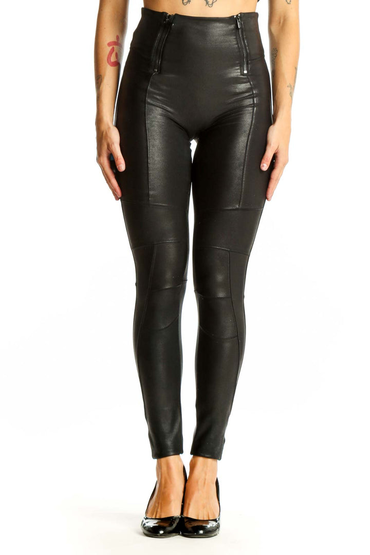Front view of Spanx black high-waisted faux leather leggings with side zippers