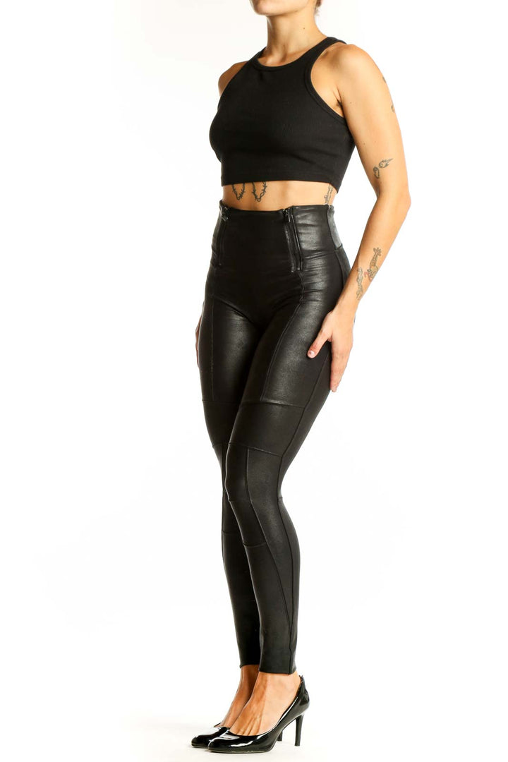 Front view of Spanx black high-waisted faux leather leggings with side zippers