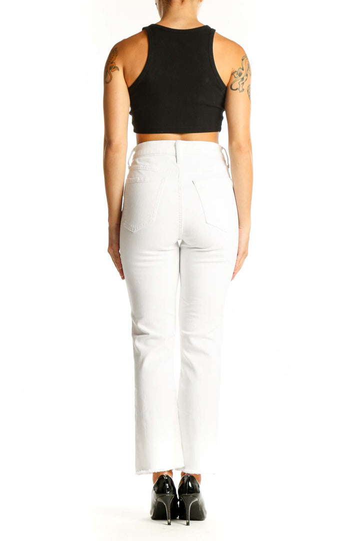 Side view of J.Crew white straight-leg jeans on model with black top