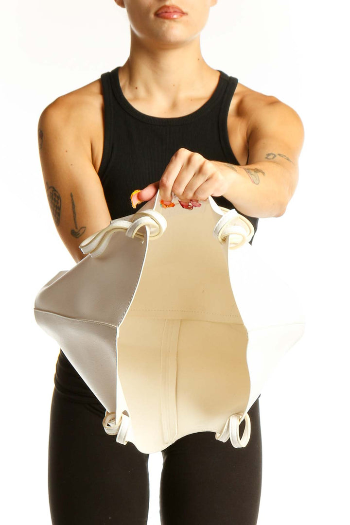 Side view of white leather Neiman Marcus tote bag worn by model