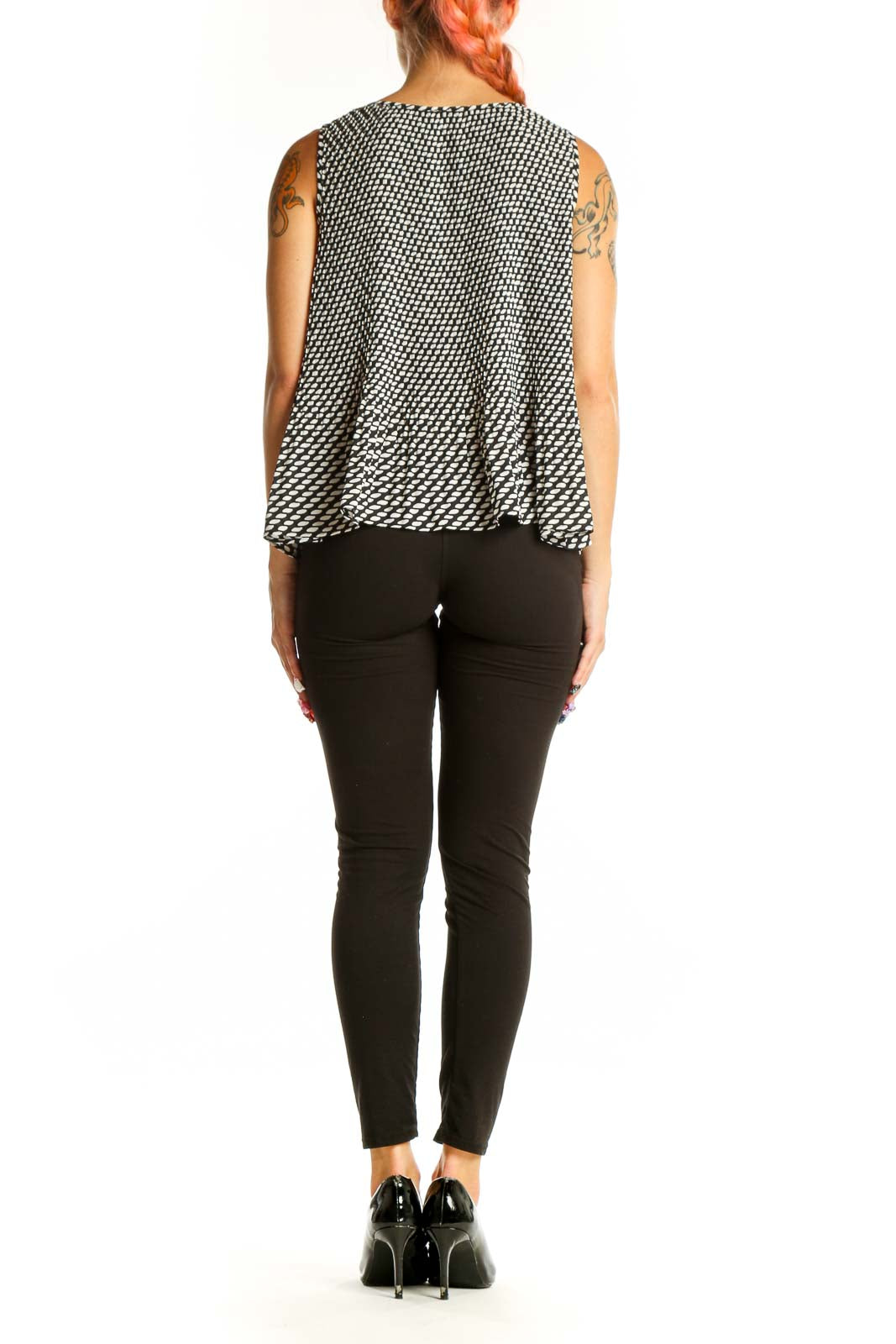 Side view of Banana Republic black and white geometric print sleeveless top with black pants