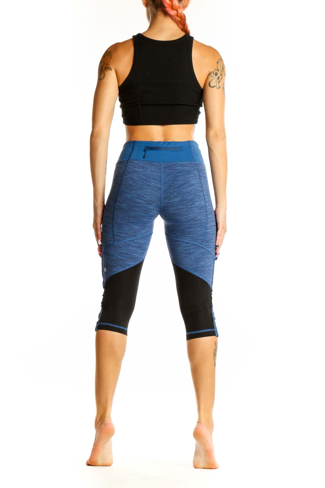 Side view of blue heathered Lululemon capri leggings showing ruched detailing