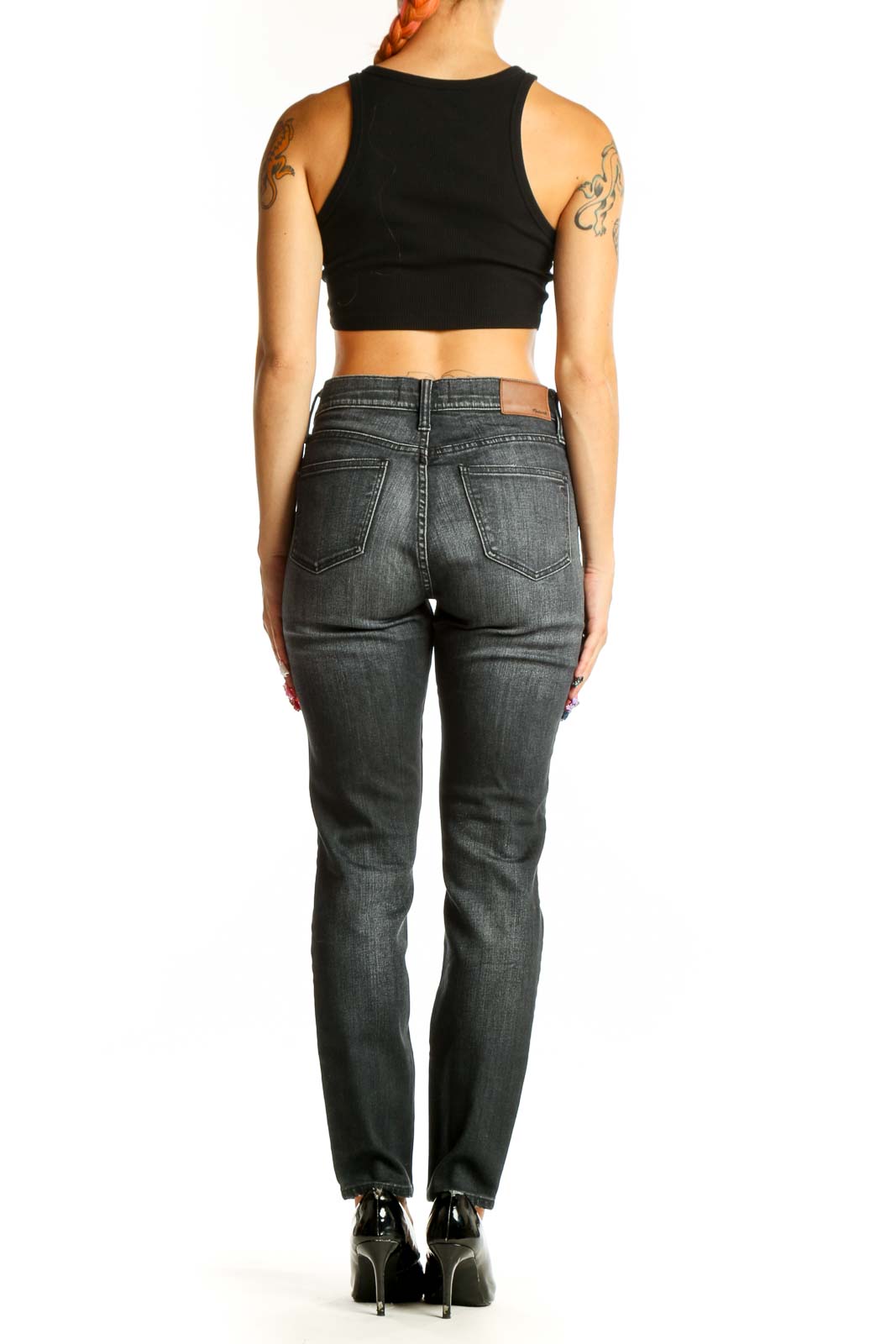 Side view of woman wearing Madewell charcoal straight leg jeans with black top
