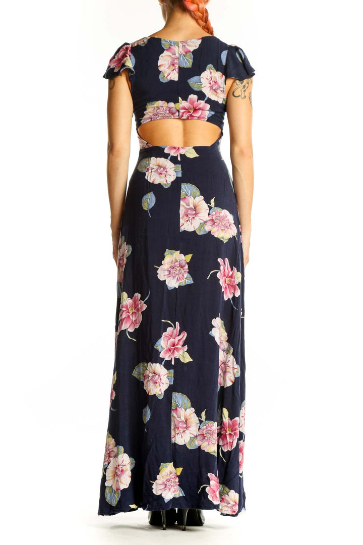 Back view of Reformed navy floral maxi dress showing full-length silhouette