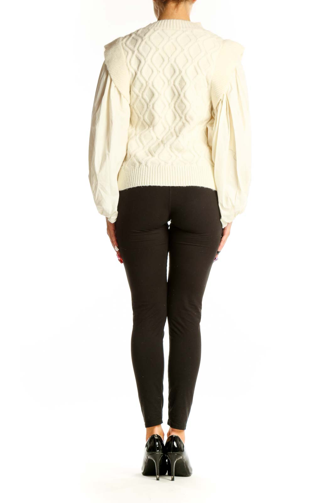 Side view of cream cable knit sweater showing puff sleeve detail