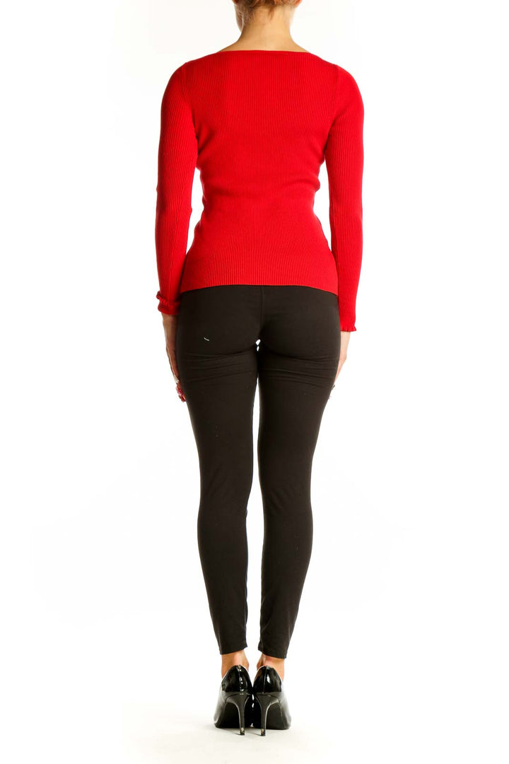 Side view of red ribbed long sleeve fitted top from Ann Taylor Petites on model