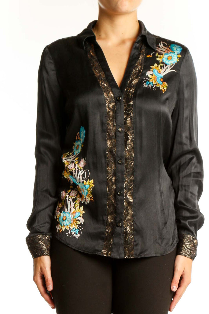 Front view of black silk Cache blouse with turquoise and gold floral embroidery