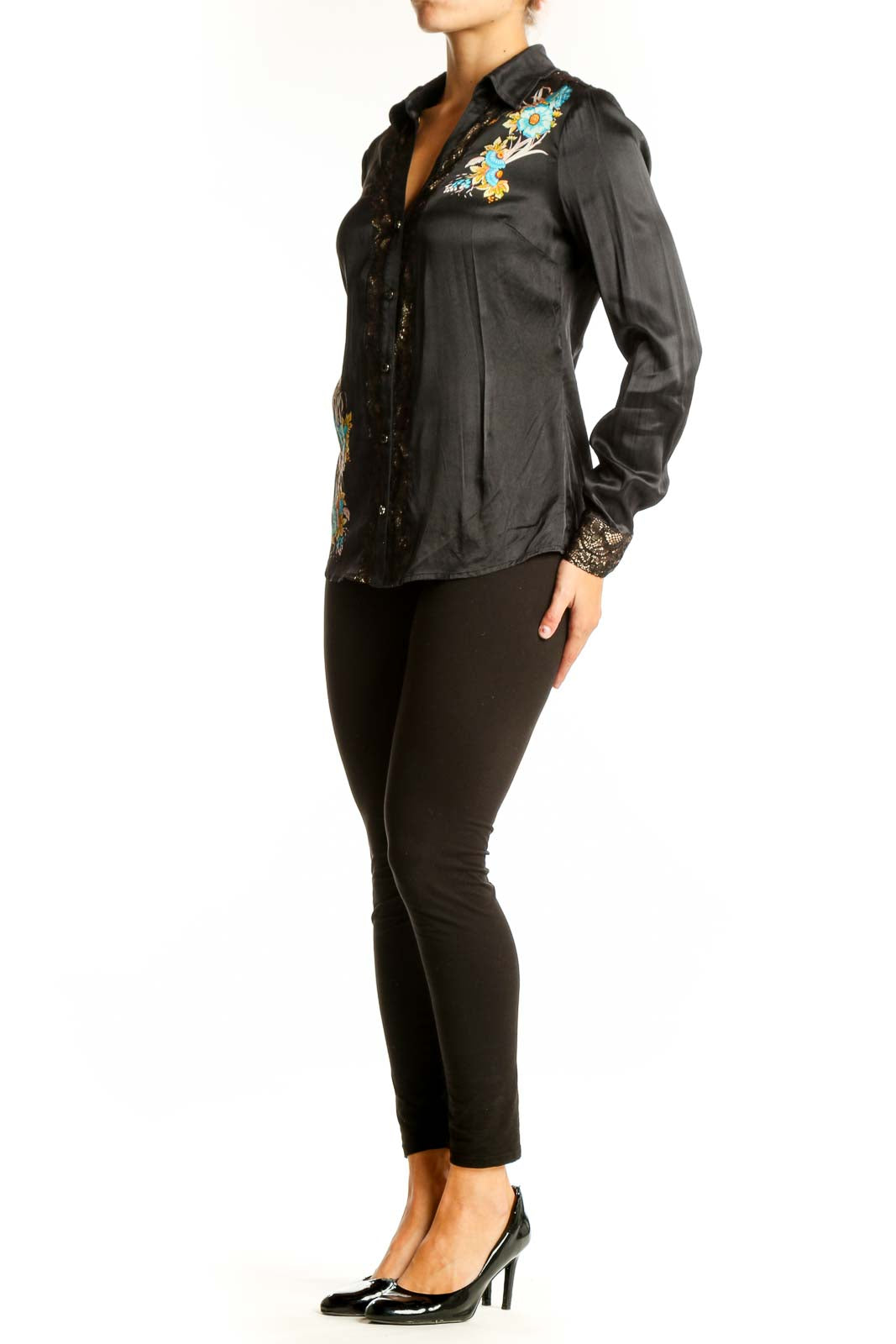 Front view of black silk Cache blouse with turquoise and gold floral embroidery
