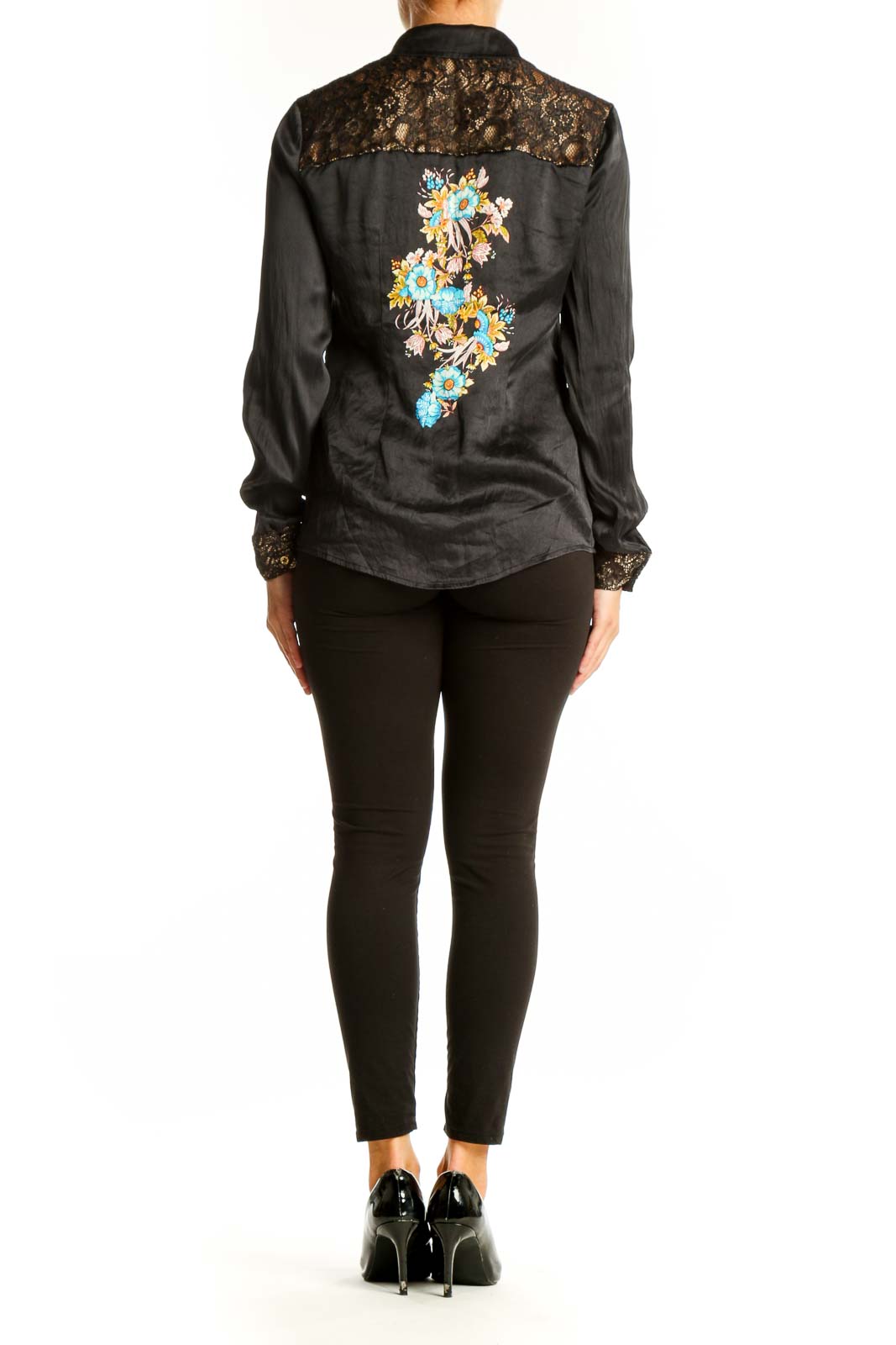 Side view of black embroidered Cache blouse showing silhouette and fit