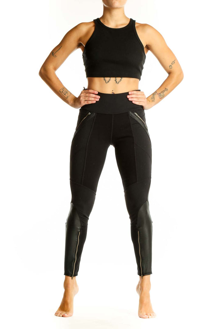 Front view of black Athleta athletic leggings with zipper pockets