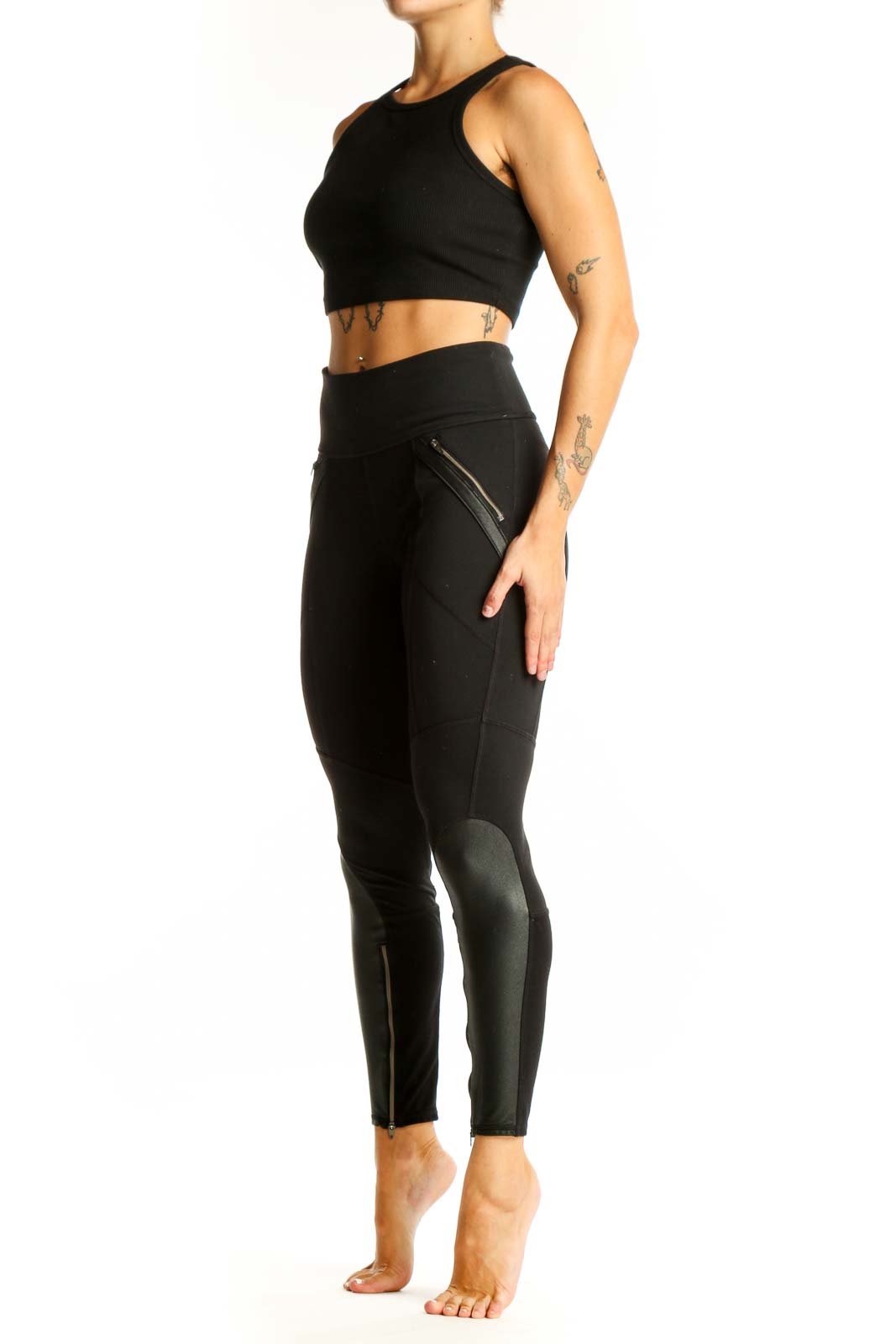 Front view of black Athleta athletic leggings with zipper pockets
