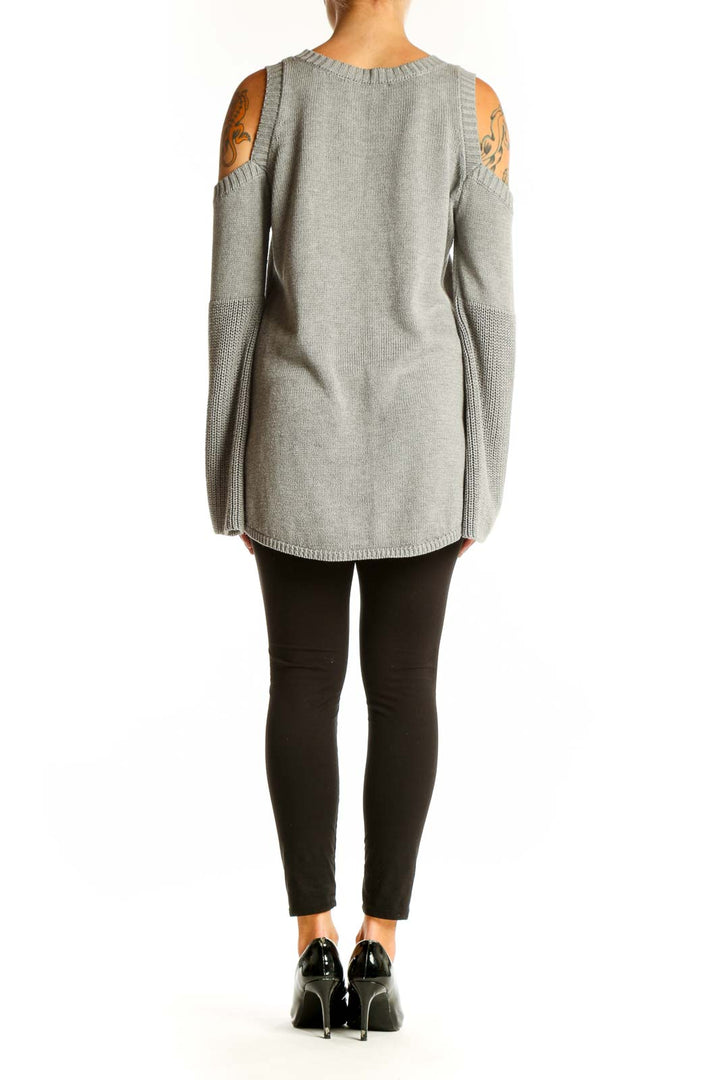 Side view of gray cold shoulder knit sweater on model