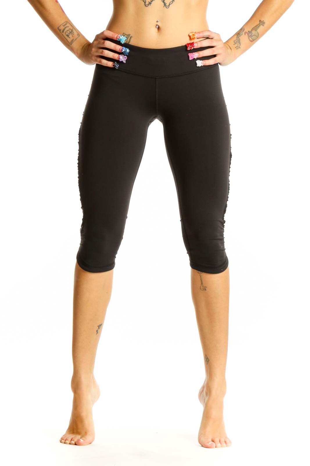 Front view of black Lululemon cropped athletic leggings on model