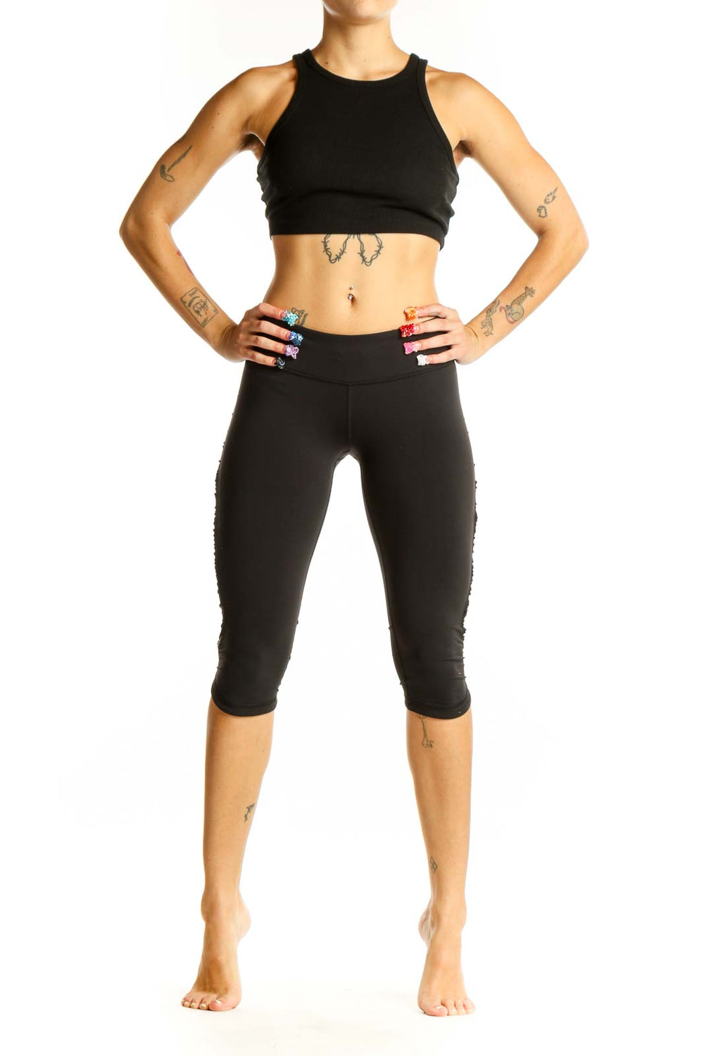 Front view of black Lululemon cropped athletic leggings on model
