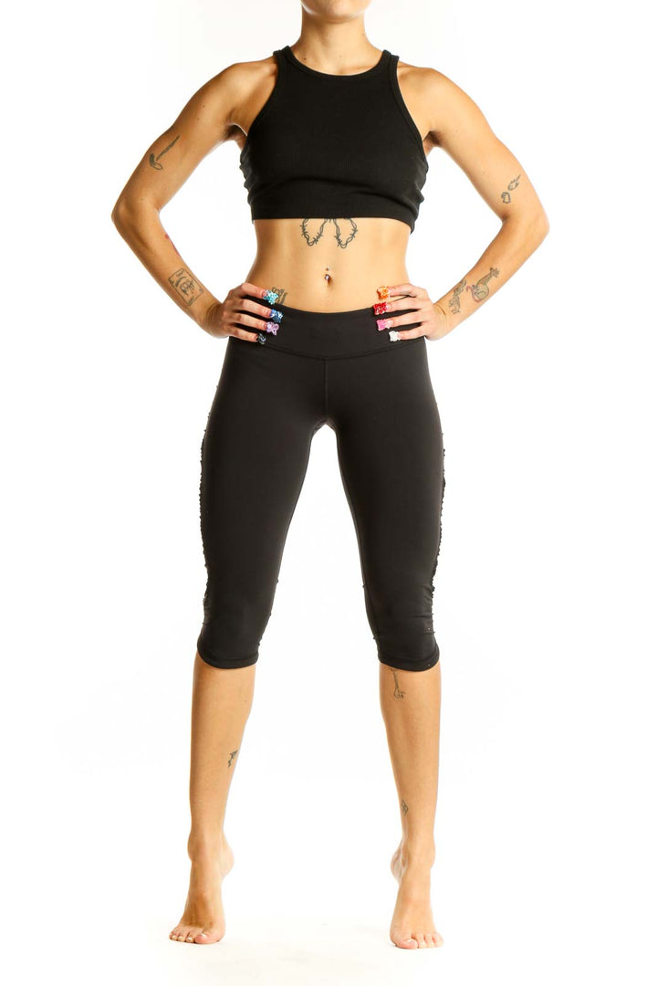 Front view of black Lululemon cropped athletic leggings on model
