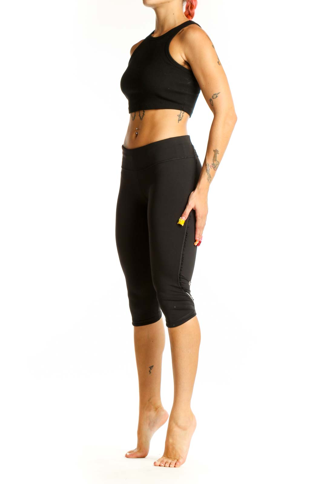 Front view of black Lululemon cropped athletic leggings on model