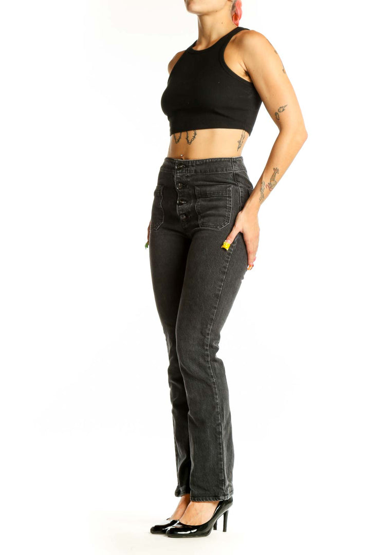 Front view of Reformation black straight leg jeans with button-fly and patch pockets