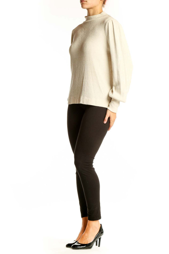 Front view of LOFT cream ribbed mock neck sweater with puff sleeves