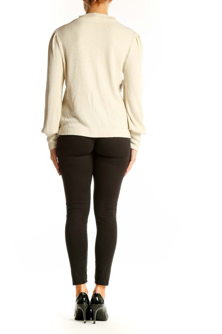Side view of LOFT cream ribbed mock neck sweater showing puff sleeve detail