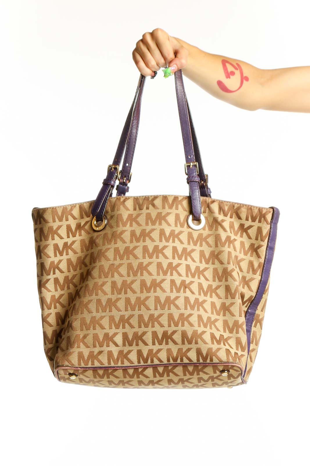 Front view of Michael Kors beige monogram tote bag with purple straps